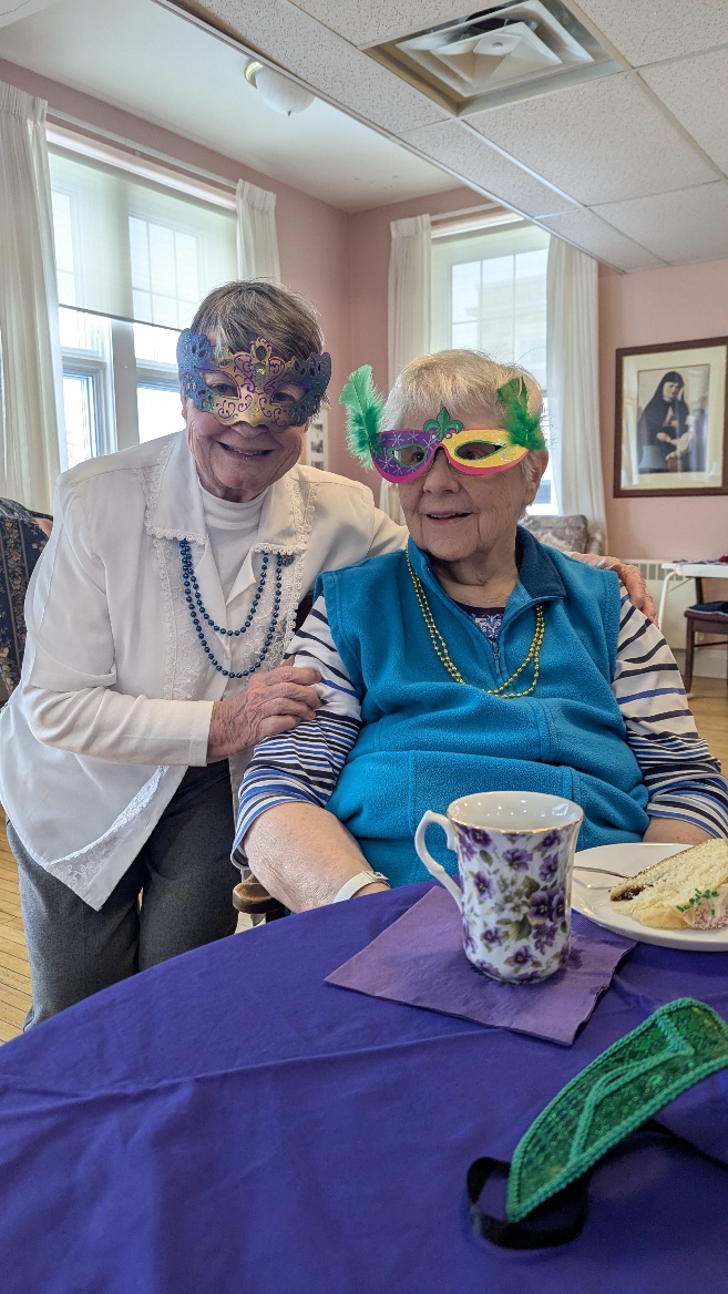 A group of elderly women sitting at a tableAI-generated content may be incorrect.