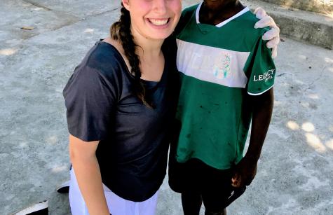 AHA student Jacklyn Kelly in Haiti with a child