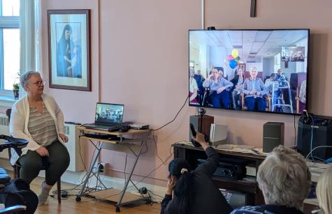 Anne MacNeil helps run the technology for the international visit Photo of SSND Sisters Virtual Visit